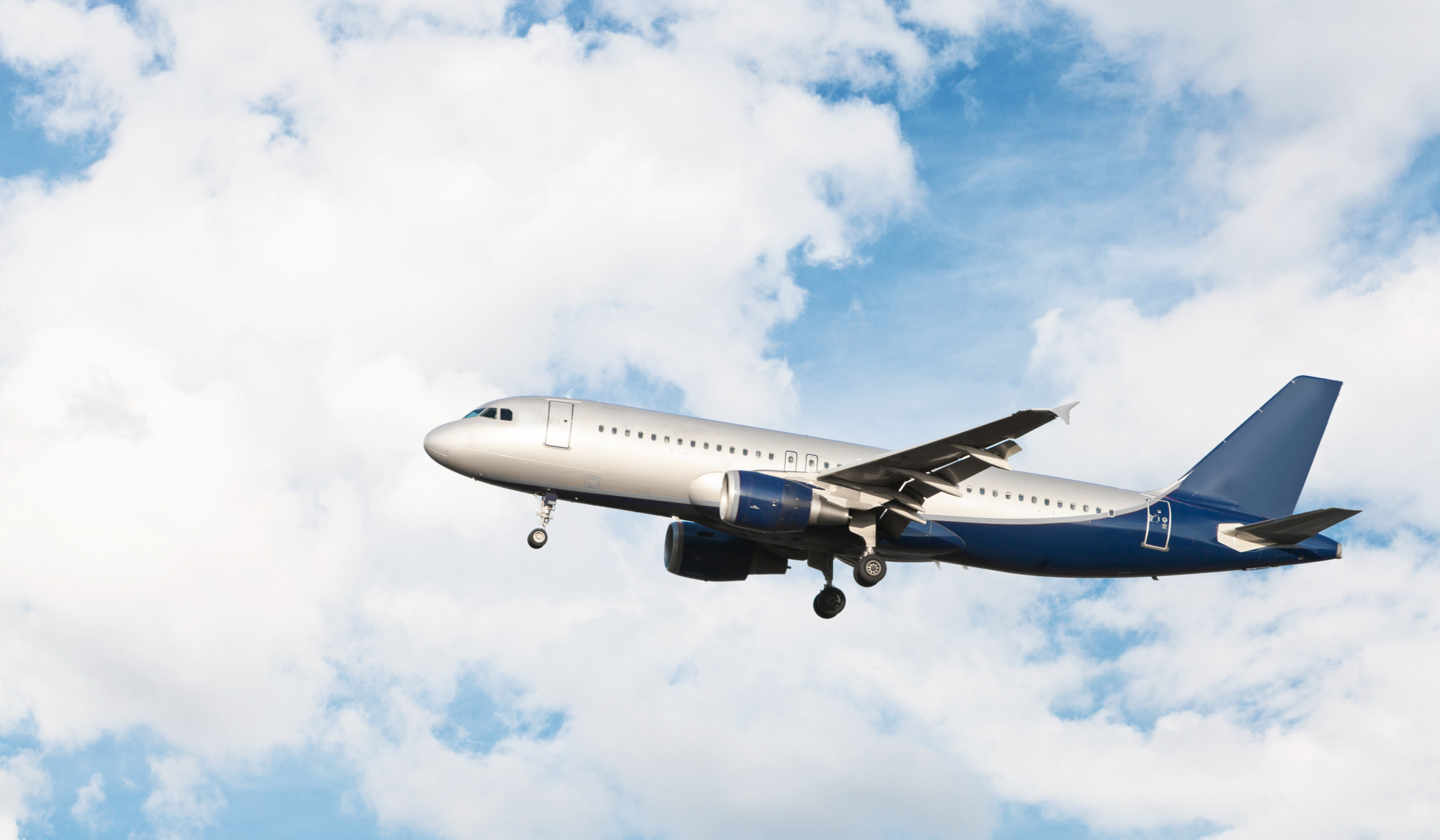 Modern airplane flying in a cloudy sky