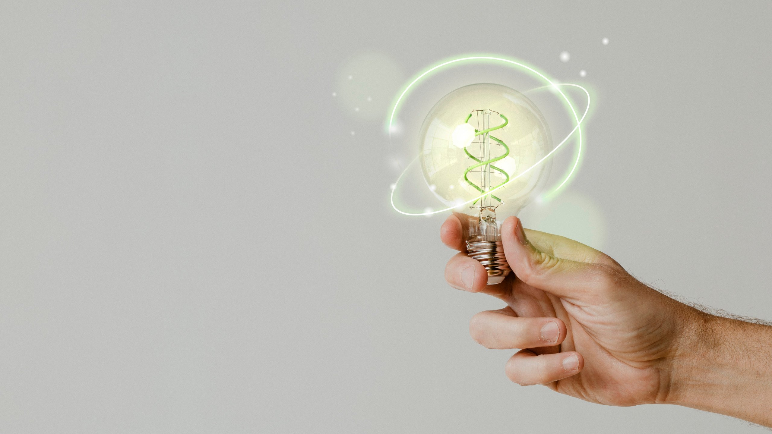 Green energy with hand holding an environmental light bulb background