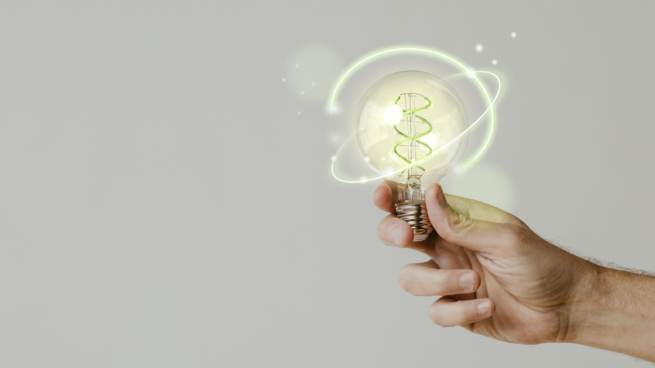 Green energy with hand holding an environmental light bulb background