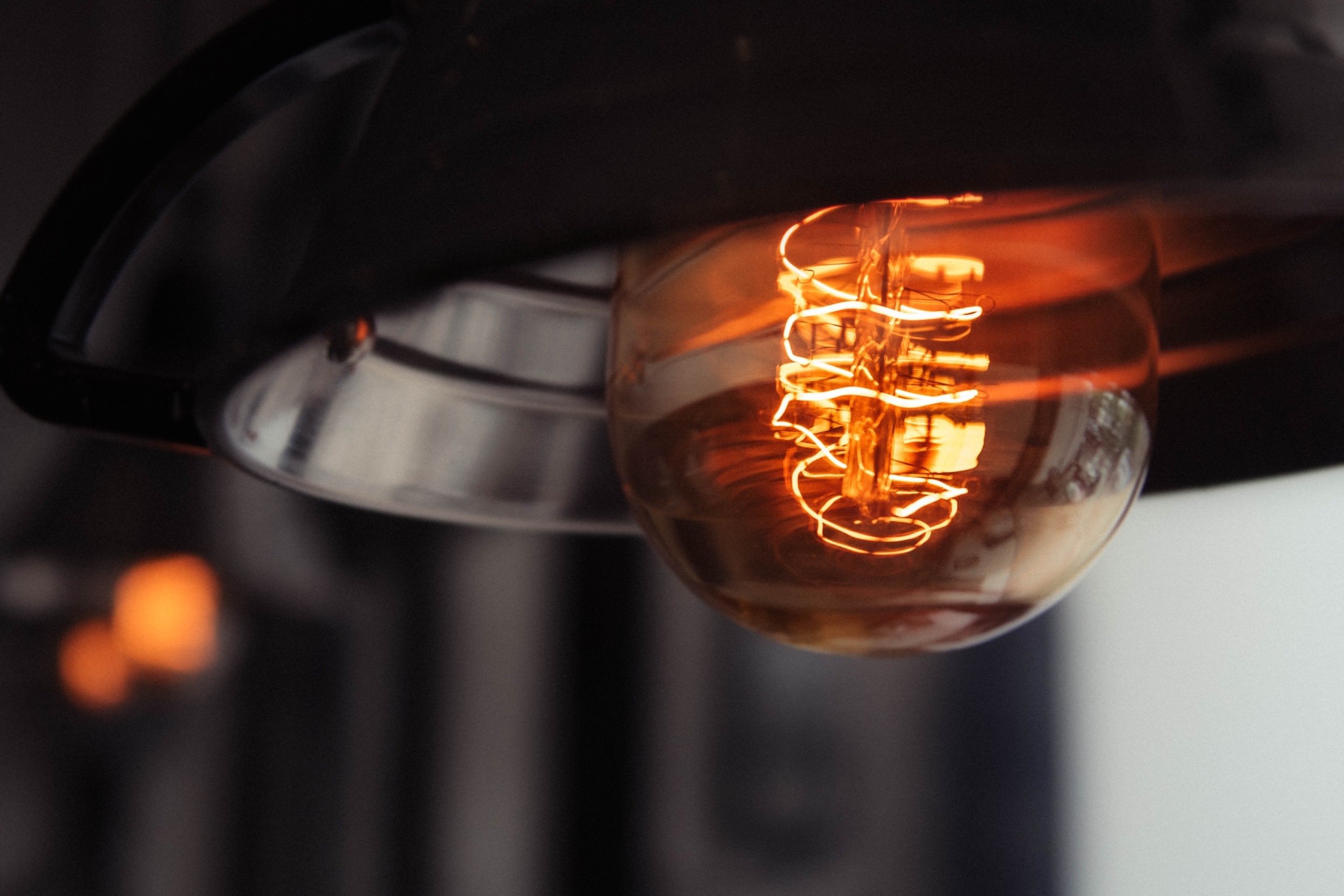 A closeup shot of a lit large lightbulb with a blurred background