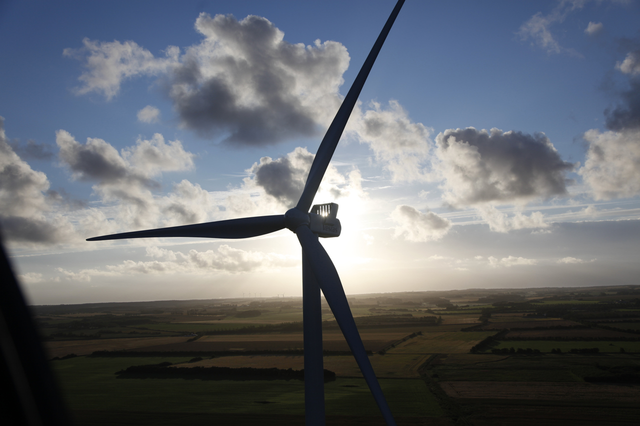 V112 3.0 MW Lem 2010 turbine against the light with blue sky and clouds